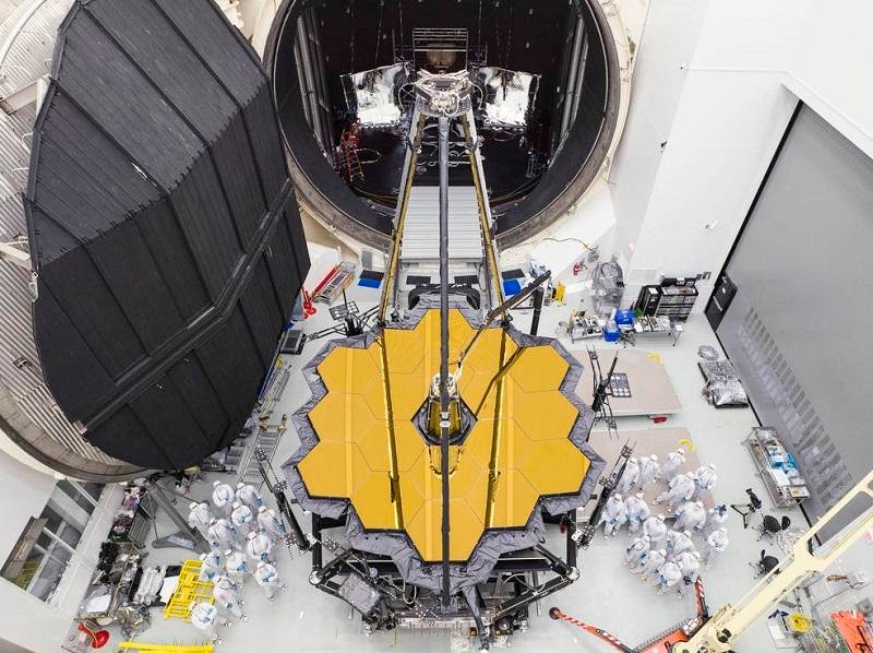 The image shows the assembly process of the James Webb Space Telescope.