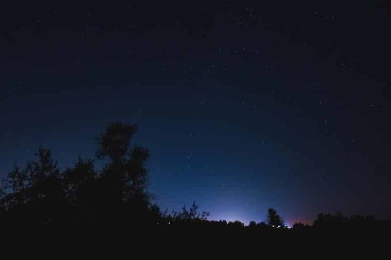 An image depicting the night sky with no visible moon, highlighting the concept of a new moon phase.