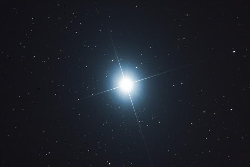 A stunning image depicting Sirius, the brightest star in the eastern sky, shining brightly at night.