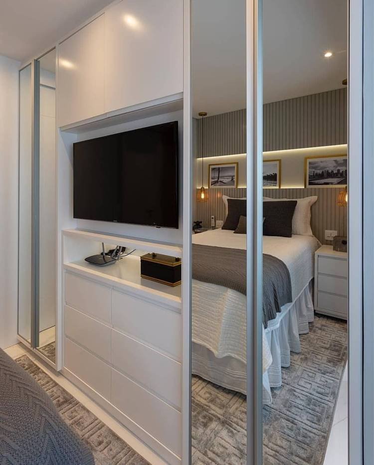 Wardrobe designed with a specific area for a TV, optimizing space.