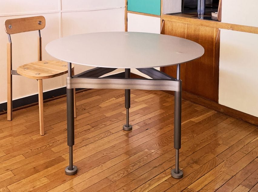 An aluminum kitchen table designed to be height-adjustable for limited spaces in the exhibition.