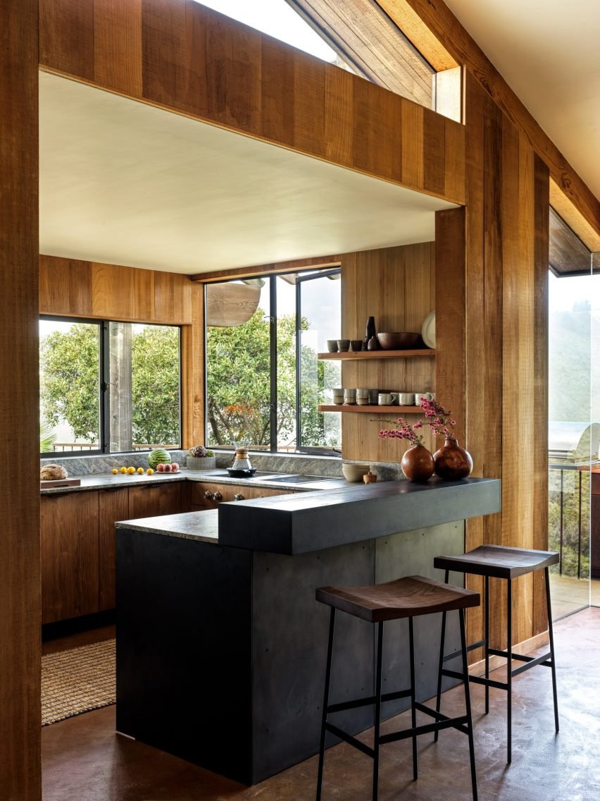 The updated kitchen has a raw steel breakfast bar, maximizing space while incorporating natural elements.