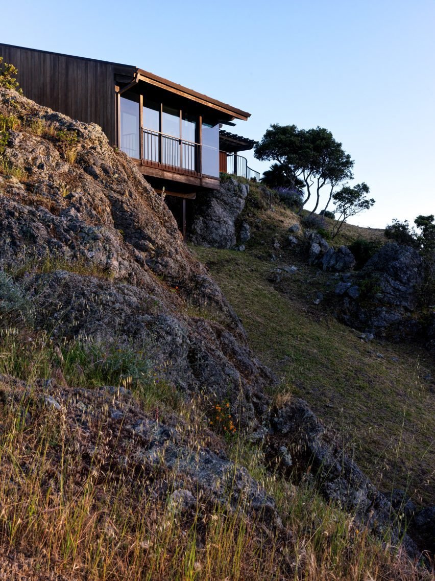 The house features a curved copper roof and redwood cladding, showcasing an organic architectural style.