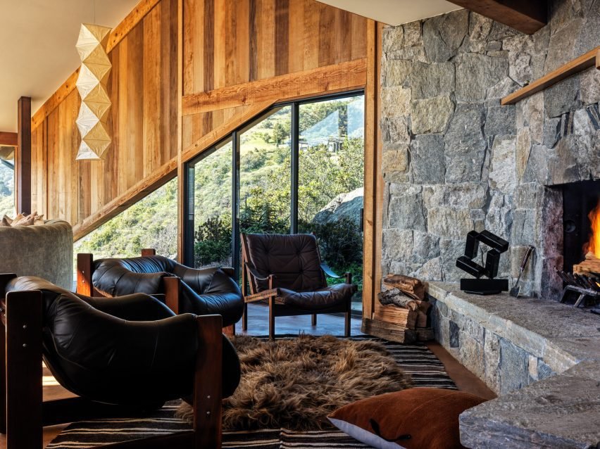 A vintage leather armchair and stone hearth add warmth to the living space.