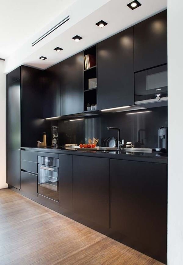 A chic black-cabineted kitchen with a stylish design