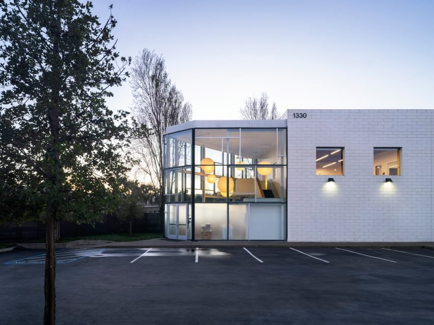 A spacious open office layout showcasing the use of Eames furniture and contemporary design.