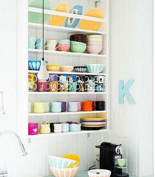 A large hollow rectangular niche with shelves delicately decorated with cute kitchen utensils, creating additional functional space.