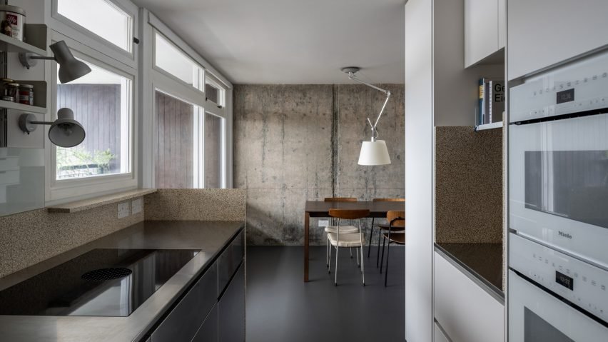 Kitchen in Trellick apartment by Archmongers featuring raw beauty of brutalist concrete.