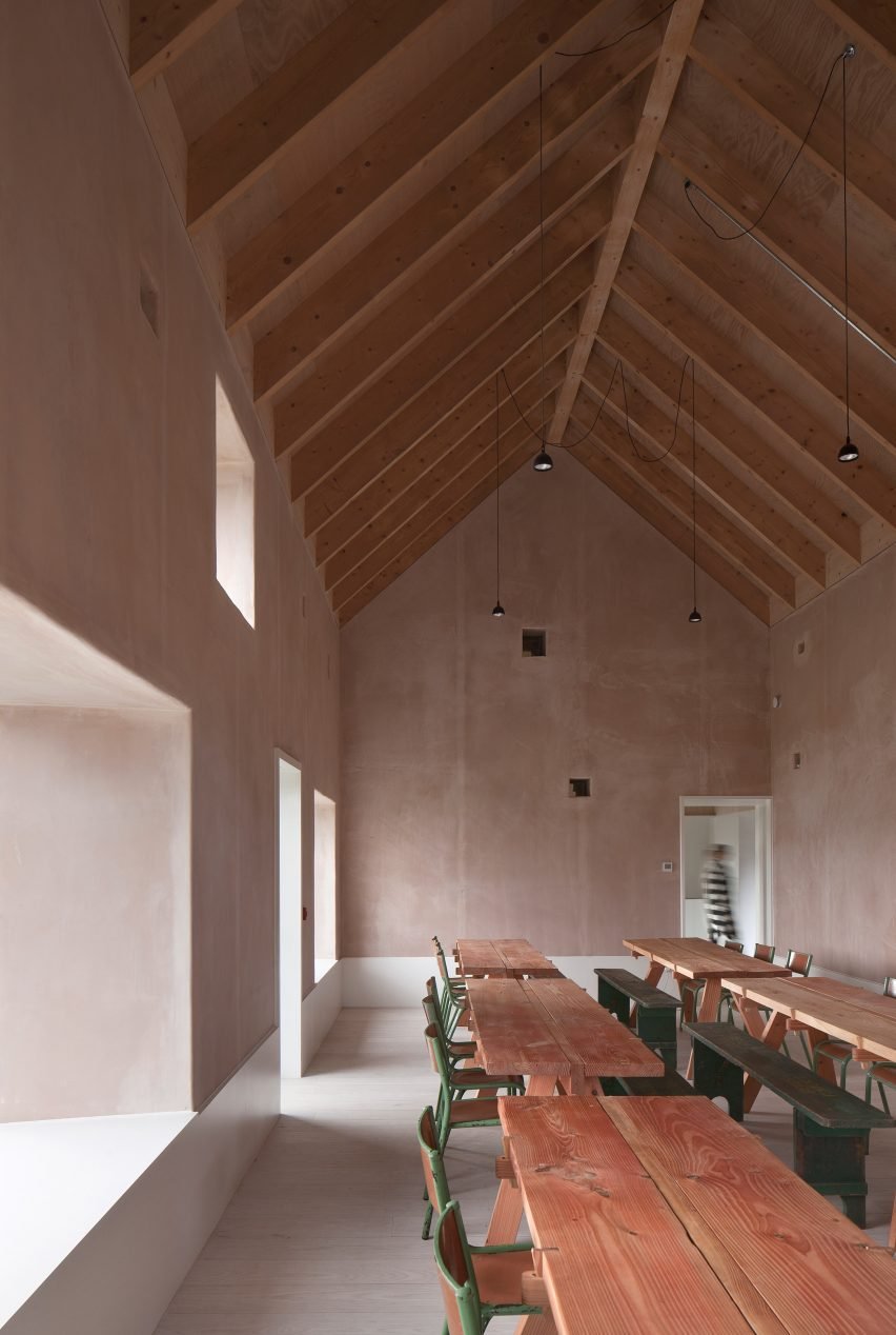 Croft 3, UK, by Fardaa: A gabled restaurant with salmon-pink exposed plaster walls and communal tables carved from Douglas fir.