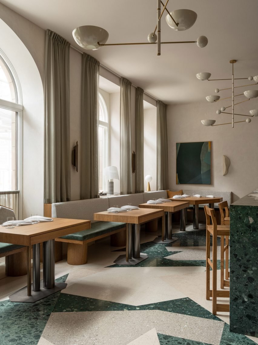 Terrazzo floor with asymmetrical patterns adding visual interest to the dining space.