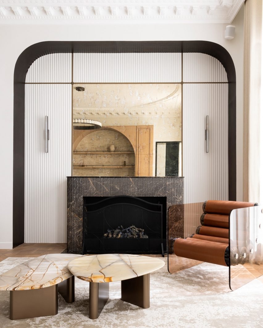 Living room featuring a dark marble fireplace surround and contemporary furniture.