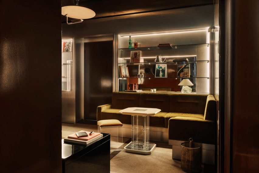 Stylish seating area with mirrored walls reflecting the retro design elements of the hotel.