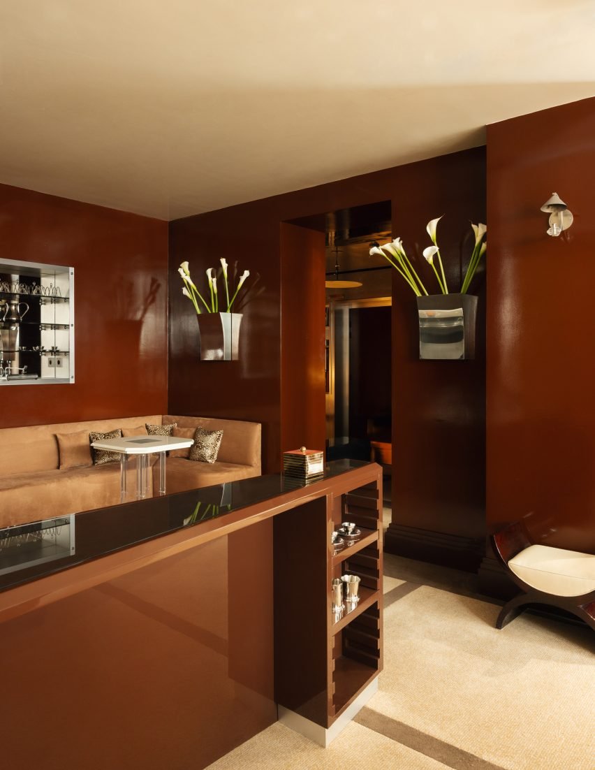 Lobby area with red walls highlighted by collectible furniture and flea market finds.