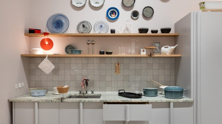 A full-size home interior installed inside the Triennale Milano showcases furniture and homeware by French designer Inga Sempé alongside dirty dishes, hanging laundry and personal trinkets.