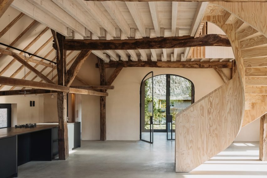 Barn at the Ahof, Netherlands, by Julia van Beuningen: A holiday home featuring a plywood spiral staircase contrasting rustic wooden beams.