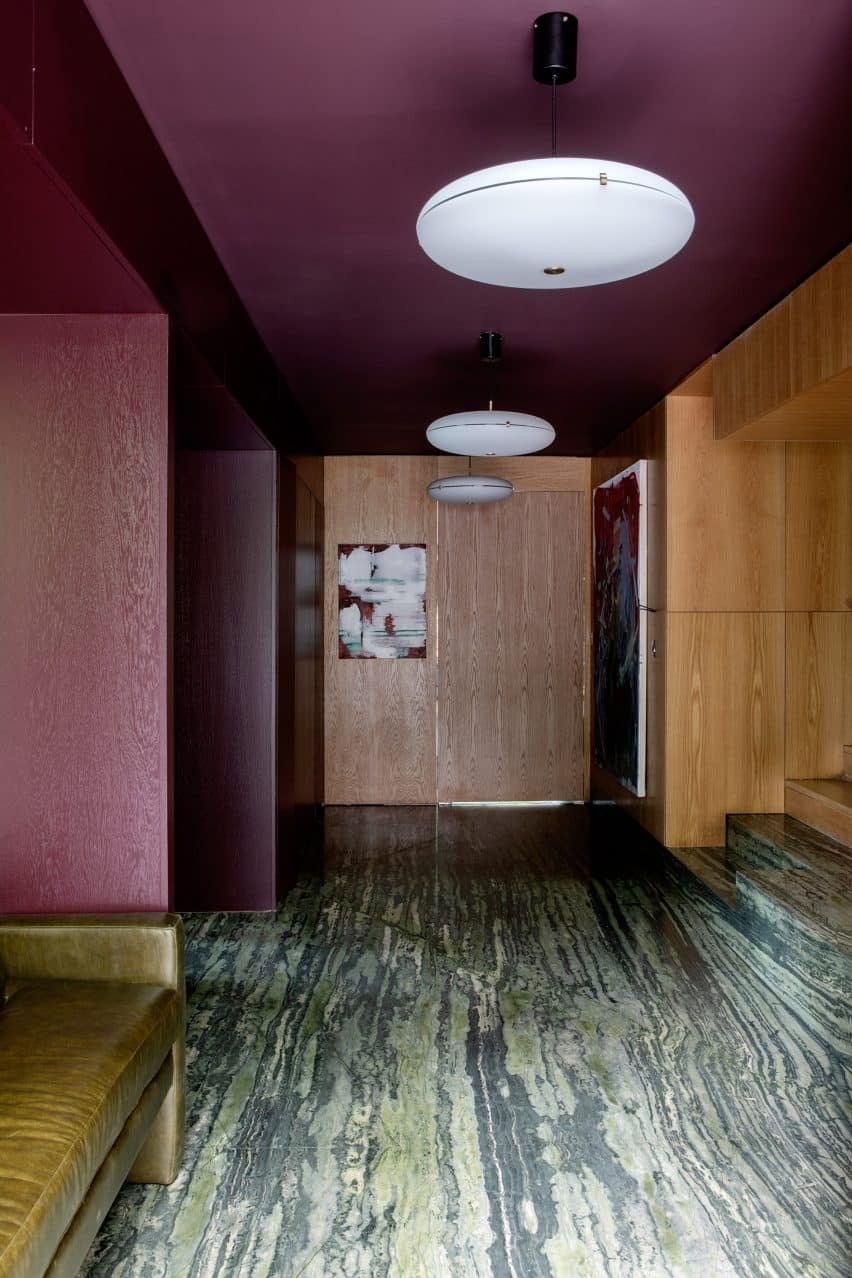 An oak-lined hallway with colourful accents leading to various rooms on the ground floor.