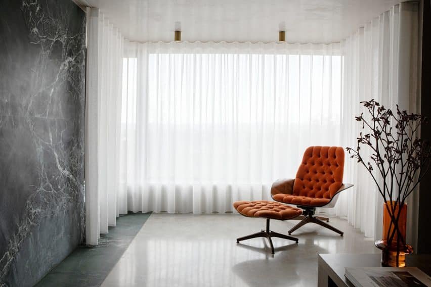 A vibrant living room featuring floor-to-ceiling curtains and a similar design palette to the kitchen.