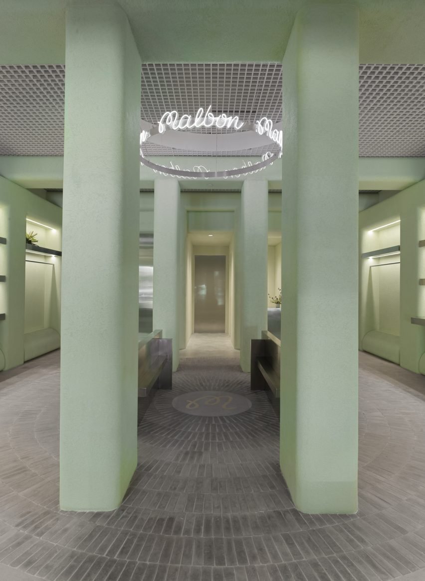 Store interior with green stucco columns and radial grey floor tiles