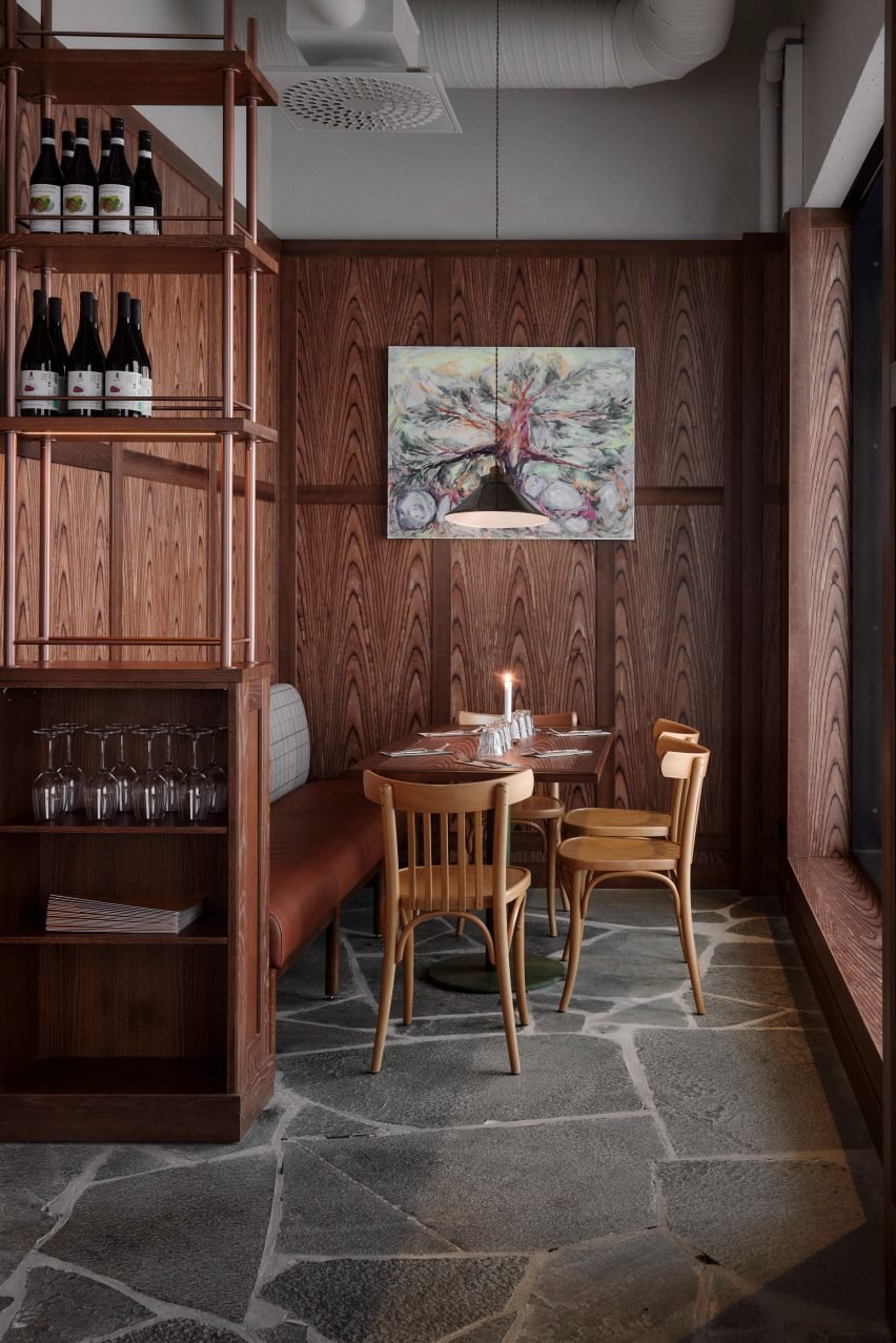 Interior featuring slate flooring and patterned timber wall panelling.