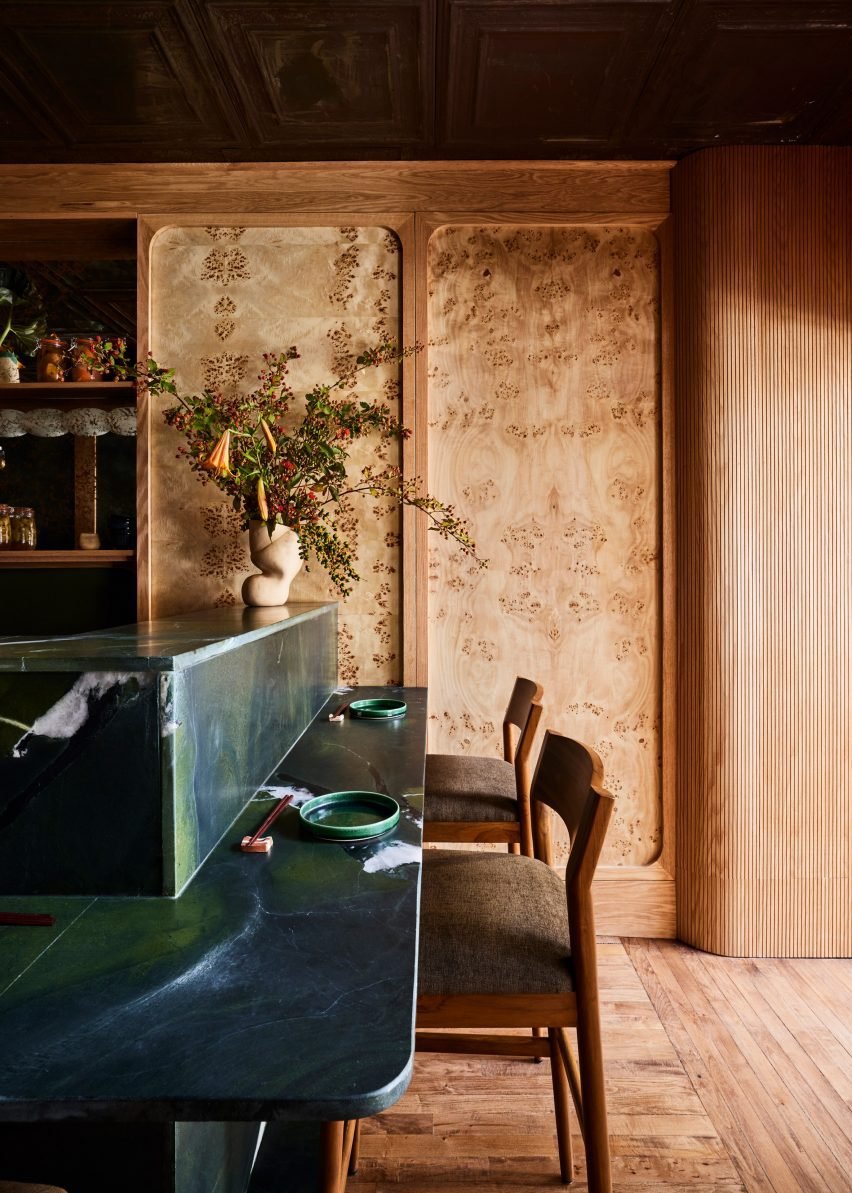 Details of the burl wood veneer panels framed in white oak on walls, which match the original parquet floors.