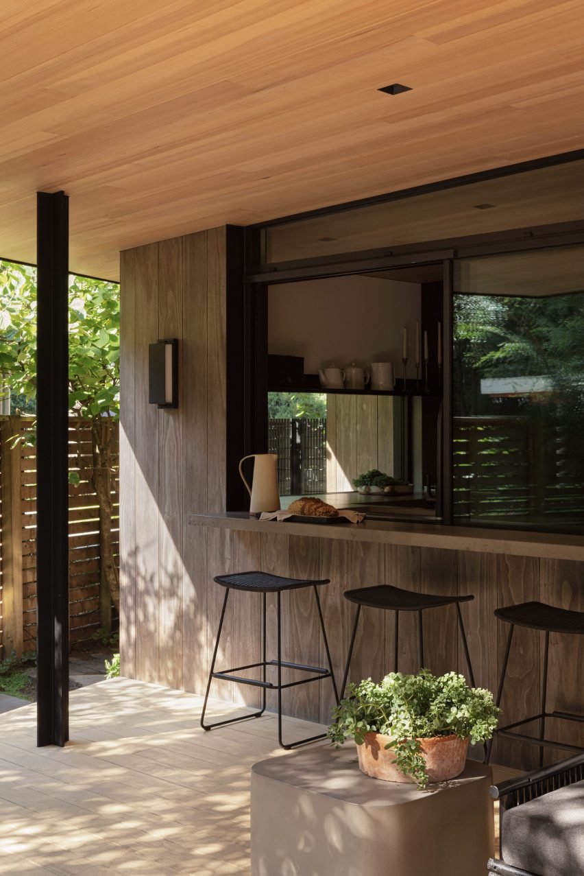 Kitchen connects to the patio via a bar counter and sliding window