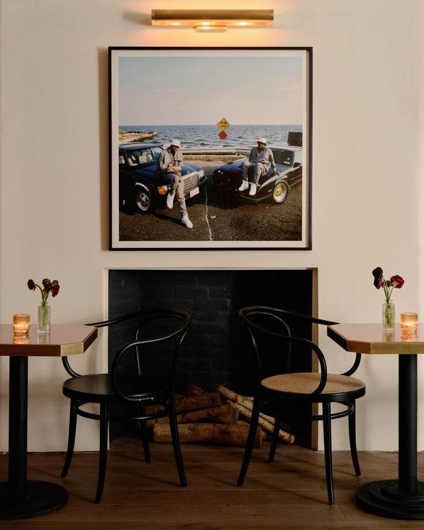 An original fireplace surrounded by two chairs, adding warmth to the interior.