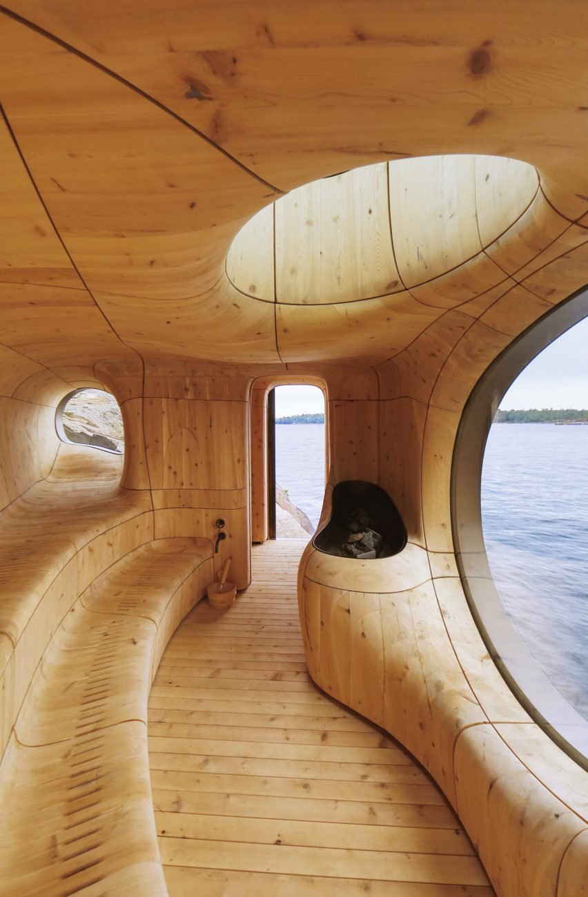 An artistic depiction of a grotto sauna designed by Partisans, featuring a unique cedar wood interior.