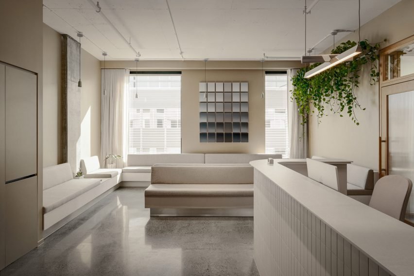 A minimalist reception area with built-in lounge seating.