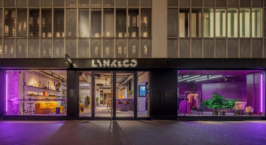 Exterior view with purple light flooding the showroom from the outside.