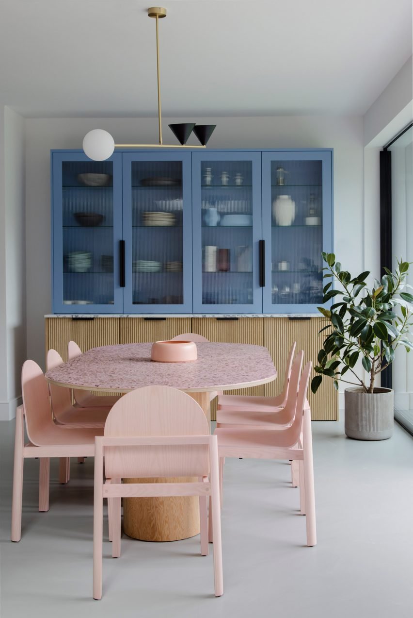 Eight-seater wooden table surrounded by delicate spindle-back chairs at Three Chimney House.