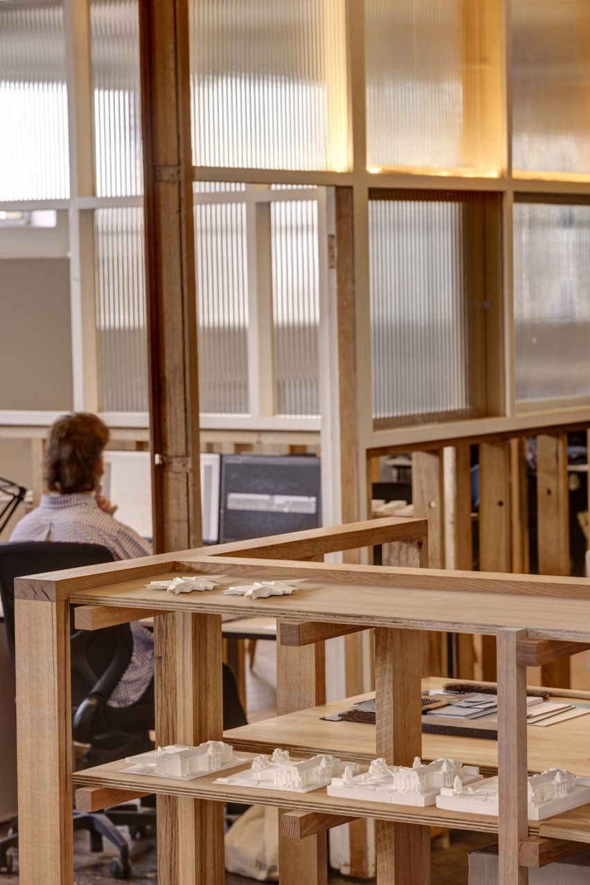 Interior view showing office shelving and a bench made from recycled timber.