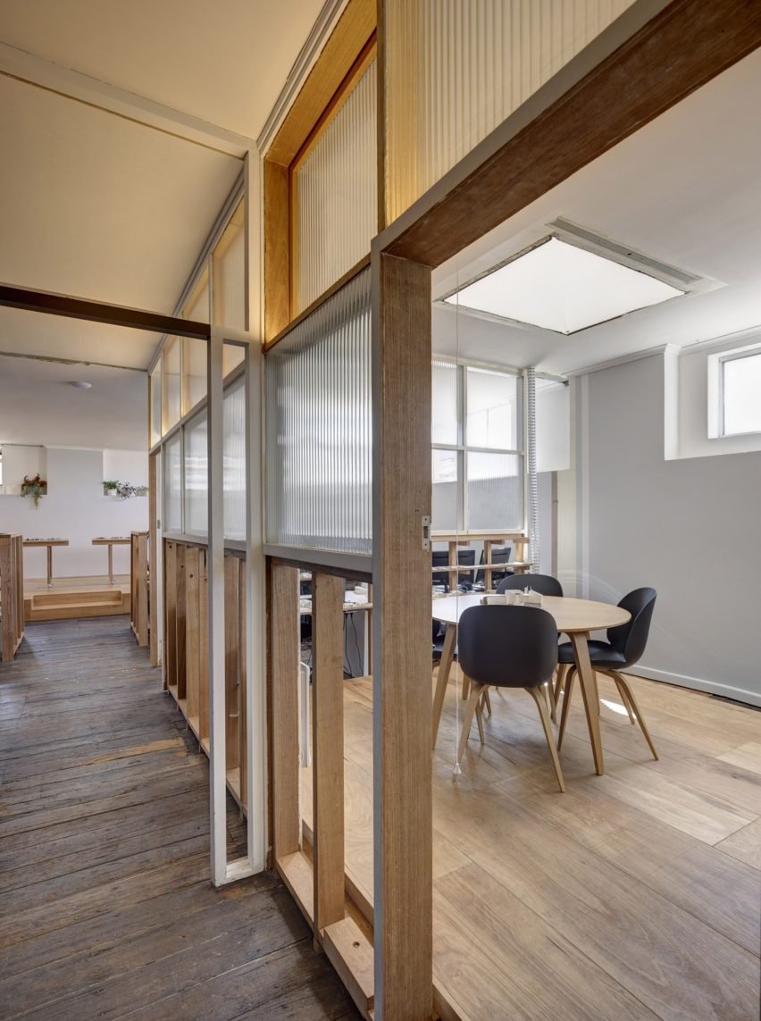 Interior view of a corridor and workspace, demonstrating the layout and design of the office fit.