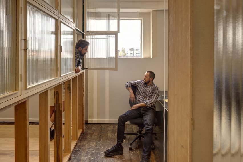 Interior view featuring cubby holes and openings in the timber framework, enhancing social connections in the workspace.