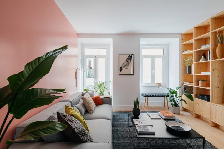 Interior living space of the converted apartment illuminated by a window.