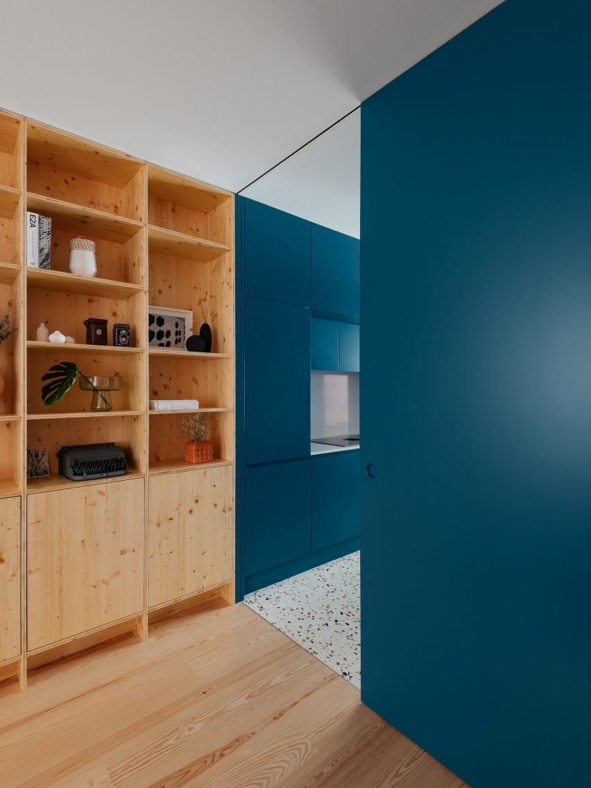 View of the kitchen with deep-blue cabinets and metal counters.