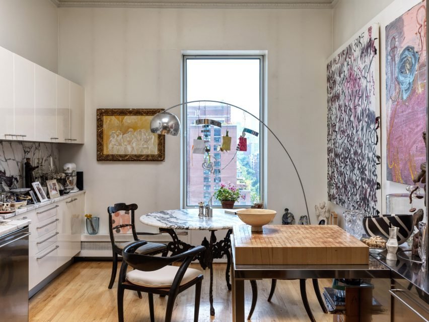 Eclectic kitchen design populated with furniture and artwork.