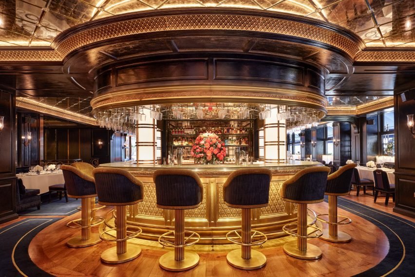 The main bar of George features high stools and intricate metal latticework