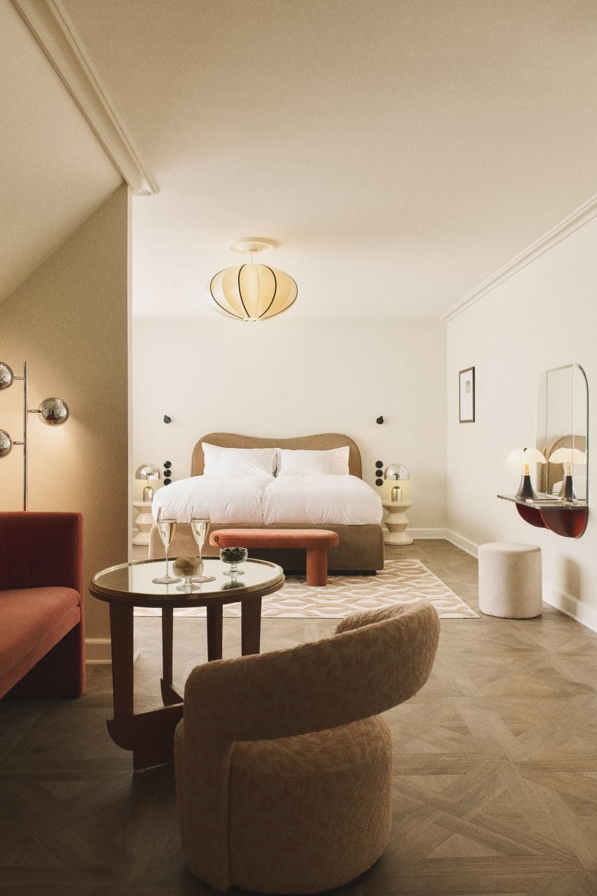 Interior of a hotel room showcasing a luxurious design with high-quality materials and midcentury Italian design references.