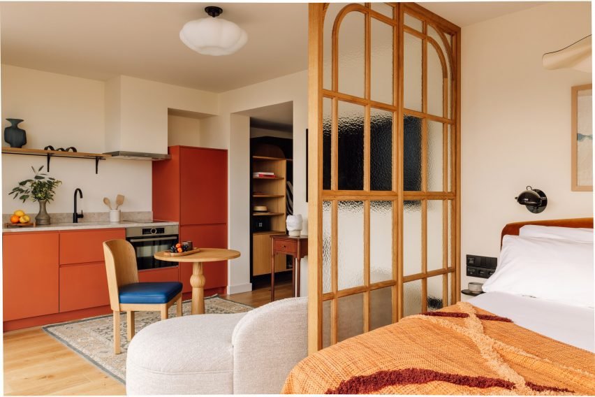 Suite-style room with living area and burnt orange kitchenette