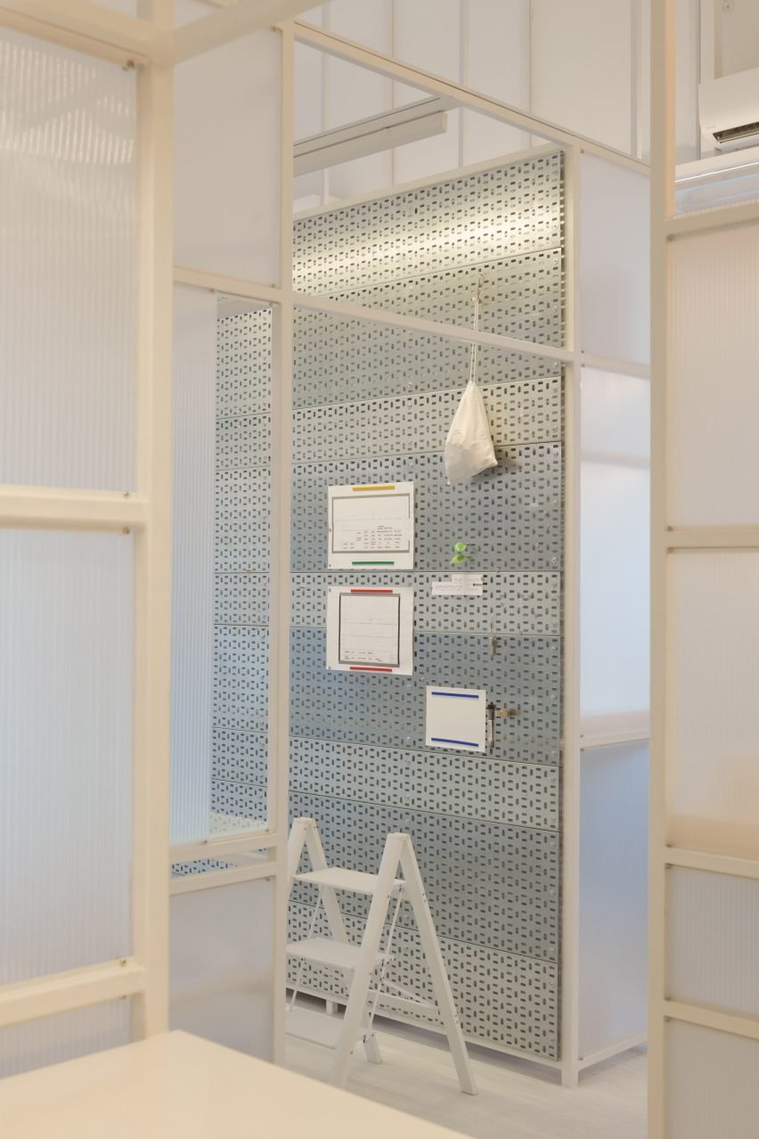 The interior design includes a wall clad with cable trays.