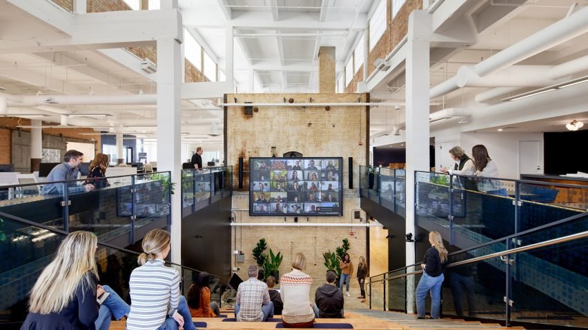 Bleacher seating facing a large screen at the offices of a Minneapolis tech company.