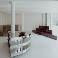 A custom-built brushed-steel staircase connects the ground floor with the basement, a carpeted space with a dressing-room feel.