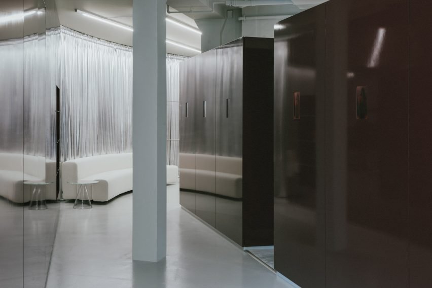 Burgundy wall units organise the ground-floor space.