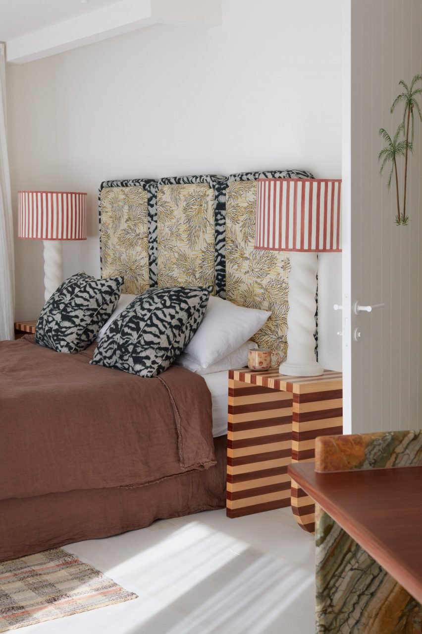 In the main bedroom of this Australian home, the headboard features clashing botanical and zebra prints.